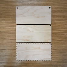 Load image into Gallery viewer, Three blank laser cut rectangular plaques, two have flat edges with rounded corners. Of those, one has round holes in the top corners and another has heart shaped holes in the top corners.
The third rectangular plaque is scalloped and has two holes in the top corners.