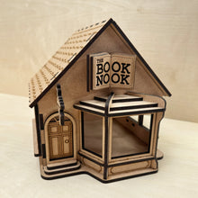 Load image into Gallery viewer, Wooden model of a bookshop engraved with the name "The Book Nook" on the sign.