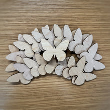 Load image into Gallery viewer, A group of twenty wooden laser cut blank butterfly shapes. Items laid out on a darker wooden background.