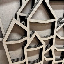 Load image into Gallery viewer, A close up view of a crystal shaped display shelf showing this version has holes built into the design.