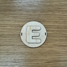 Load image into Gallery viewer, A wooden laser cut circular bead shape with a layered letter "E" to build a friendship bracelet bunting.