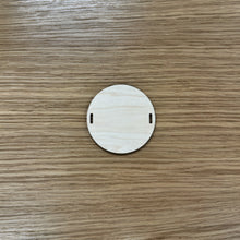 Load image into Gallery viewer, A blank wooden laser cut circular bead shape to build a friendship bracelet bunting.