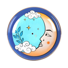 Load image into Gallery viewer, A ceramic incense bowl with a vintage tarot themed moon illustration. The yellow crecent moon has a calm face looking to the centre on a light blue background. Also depicted are white clouds, yellow stars and a blue plant growning from a cloud. The image is framed with a ring of darker blue and the lip or edge of the bowl is lined with a gold like finish. There is a hole in the centre of the bowl to hold an insence stick. The bowl is on a white background.