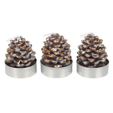 Load image into Gallery viewer, Three pine cone-shaped candles in metal holders on a white background