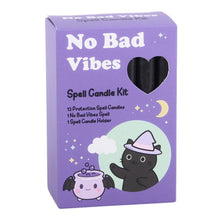 Load image into Gallery viewer, A purple box with a black cat cartoon over a cartoon cauldron with bat wings on the cover. At the top: "No Bad Vibes" is written in white and below that: "Spell Candle Kit" Along with the contents of the box in black text: "12 Protection Spell candles. 1 no bad vibes spell and 1 spell candle holder." The cover also contains small clouds, a crescent moon and stars around the box. Item on a white background.