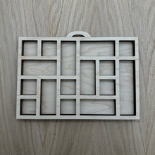 Load image into Gallery viewer, A miniature wooden laser cut tray divided into sections to mimic the old type setter trays. Item on a wooden background.