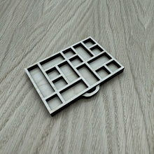 Load image into Gallery viewer, A miniature wooden laser cut tray divided into sections to mimic the old type setter trays. Item on a wooden background.