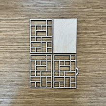 Load image into Gallery viewer, A miniature wooden laser cut tray divided into sections to mimic the old type setter trays. The layers are laid out on a wooden background.