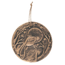 Load image into Gallery viewer, A terracotta plaque with a Gazing Hare. The design also features a full moon, stars, and two trees surrounding the plaque. The plaques have a copper effect and string loop for hanging.