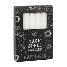 Load image into Gallery viewer, A pack of 12 black Magic Spell Candles in a black cardboard box with a witch themed pattern and the word "Happiness" at the bottom. The white candles can be seen in a cut out window in the packaging. Item on a white background.