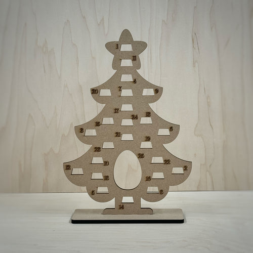 Freestanding MDF Christmas tree Advent calendar on a wooden background. 