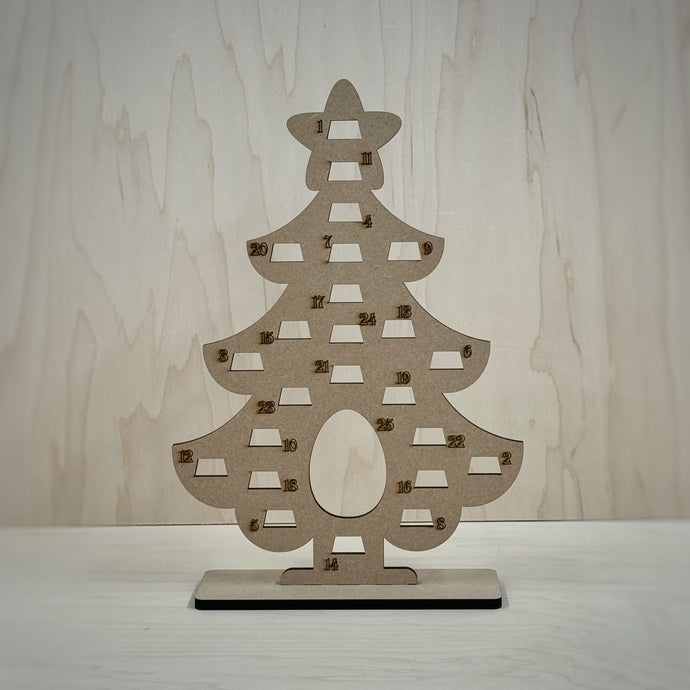 Freestanding MDF Christmas tree Advent calendar on a wooden background. 