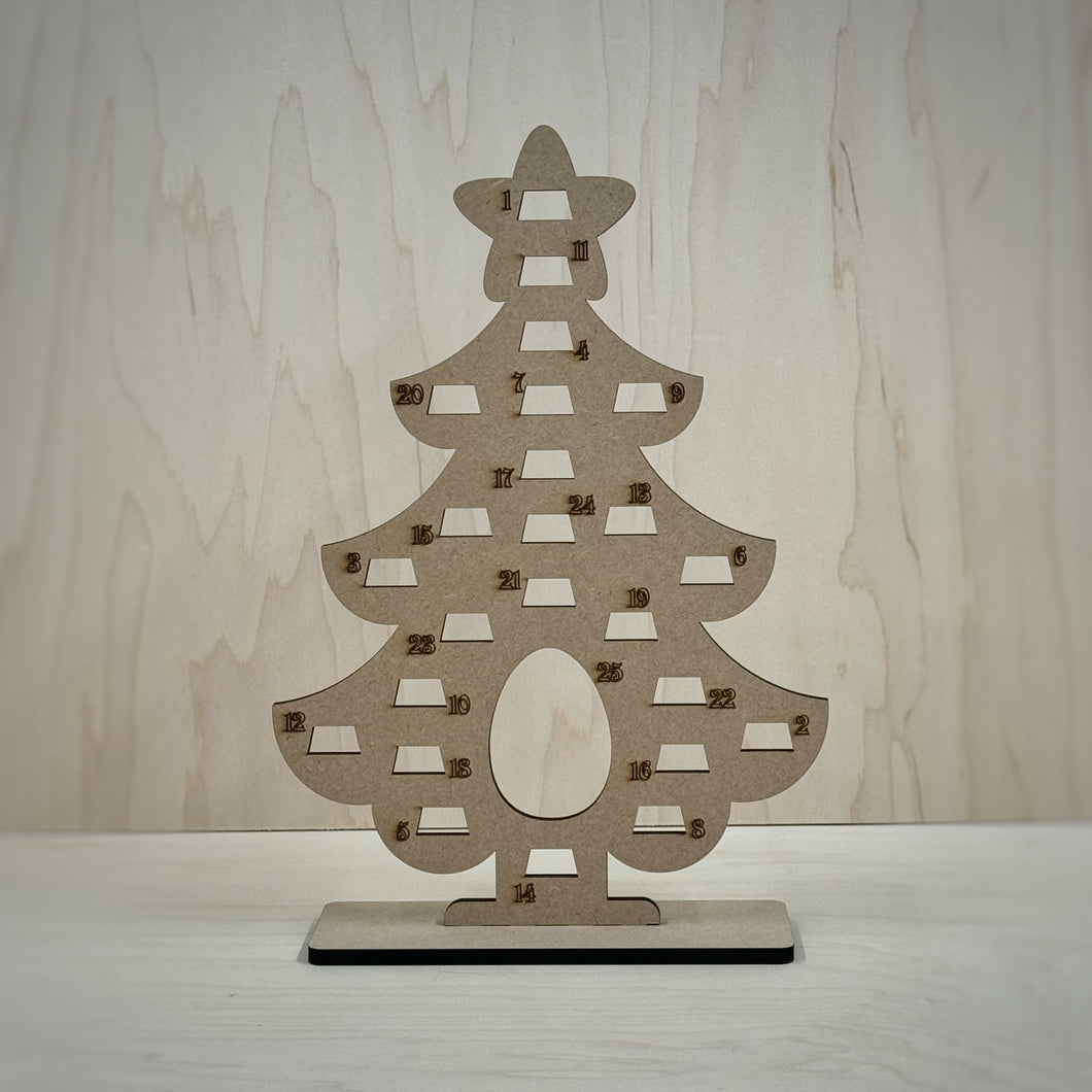 Freestanding MDF Christmas tree Advent calendar on a wooden background. 