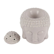 Load image into Gallery viewer, A small grey ceramic oil burner shaped like a Buddha head. The lid is off and to the side. Both is on a white background.
