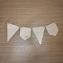 Load image into Gallery viewer, A selection of wooden laser cut bunting shapes. One scalloped triangle bunting, a plain pennant bunting, a plain triangle bunting, and a scalloped pennant bunting. Items on a darker wooden surface.
