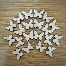Load image into Gallery viewer, A group of twenty wooden laser cut blank butterfly shapes. Items laid out on a darker wooden background.
