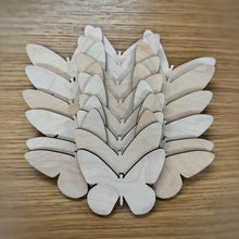 Load image into Gallery viewer, A group of twenty wooden laser cut blank butterfly shapes. Items laid out on a darker wooden background.
