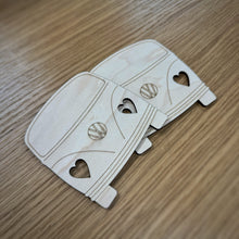 Load image into Gallery viewer, Two wooden laser-cut van-shapes with heart-shaped headlights cut out. Displayed on a wood grain surface.
