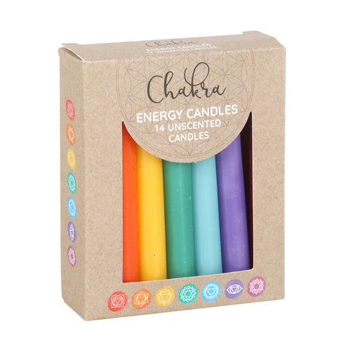 A pack of 14 unscented, multicolored energy candles, with each candle representing a different chakra color, displayed in a cardboard box with 'Chakra' branding and a description of the product's use for meditation and yoga.