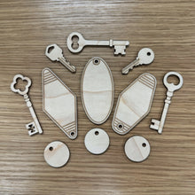 Load image into Gallery viewer, Laser-cut wooden key &amp; keyring shapes, displayed on a wood grain surface.

