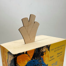 Load image into Gallery viewer, A laser cut bookmark in the shape of a Leek, poking out of a thick book.

