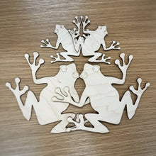 Load image into Gallery viewer, Four laser cut frog shapes showing both sizes available.
