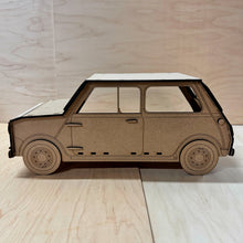 Load image into Gallery viewer, The side of a 3D MDF laser cut cupcake stand in the shape of a classic mini car. Item has layered wheels, door hinges, door handle, and fuel cap. Item on a light wooden background. 
