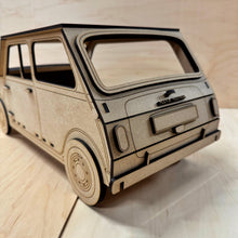 Load image into Gallery viewer, The back corner of a 3D MDF laser cut cupcake stand in the shape of a classic mini car. Item has layered lights, bumpers, license plate, logo and other parts. Item on a light wooden background. 
