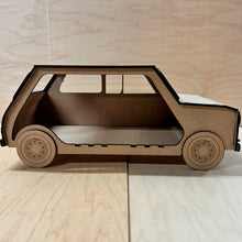 Load image into Gallery viewer, The side of a 3D MDF laser cut cupcake stand in the shape of a classic mini car with this right side open to allow storage for extra cupcakes. Item has layered wheels and is on a light wooden background. 
