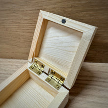 Load image into Gallery viewer, A close up of small blank wooden keepsake box with an open lid, showing brass hinges and a magnetic clasp in a light natural wood, placed on a darker wooden surface.
