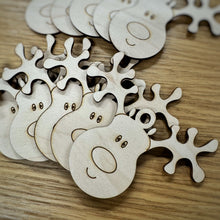 Load image into Gallery viewer, A close up of a set of laser cut wooden reindeer tags or ornaments.
