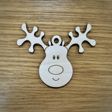 Load image into Gallery viewer, A single laser cut wooden reindeer tag on a darker wooden background.
