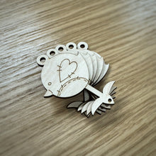 Load image into Gallery viewer, A stack of five wooden laser cut robin shaped tags with a stitching style pattern engraved on them. They have a loop hole at the top of the robin and a small hole at the bottom on the foot.
