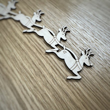 Load image into Gallery viewer, A close up of a wooden laser cut of reindeer as part of a sleigh design on a wooden surface
