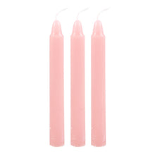 Load image into Gallery viewer, Three light pink taper candles with white wicks, arranged vertically side-by-side on a plain white background.
