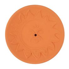 Load image into Gallery viewer, A terracotta incense stick holder plate with an embossed sun and face design.
