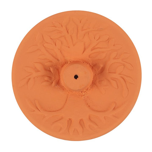 A terracotta incense stick holder with an embossed tree of life design.