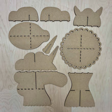 Load image into Gallery viewer, A collection of parts that make up a unicorn cupcake stand, laid out on a wooden surface.
