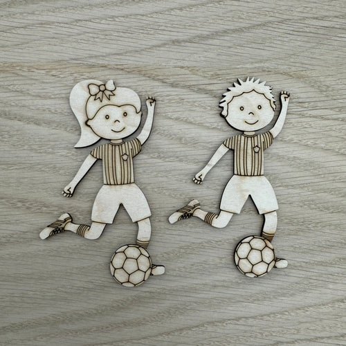 Two laser cut shapes of kids playing football