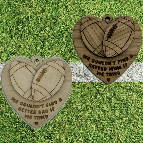 Two laser cut hearts with layered rugby balls and engraved with a message.