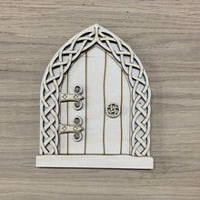 Load image into Gallery viewer, A wooden laser cut Celtic Fairy Door with intricate knotwork design. Item displayed on a wooden background.
