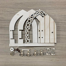 Load image into Gallery viewer, A wooden laser cut Celtic Fairy Door with intricate knotwork design and a functioning hinged door with all the parts laid out on a wooden background.
