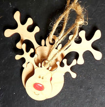 Load image into Gallery viewer, Two laser cut wooden reindeer shapes in two sizes. Their noses are painted red and each has a jute string for hanging. Items on a black slate background.
