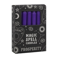 Load image into Gallery viewer, A pack of 12 black Magic Spell Candles in a black cardboard box with a witch themed pattern and the word "Prosperity" at the bottom. The purple candles can be seen in a cut out window in the packaging. Item on a white background.
