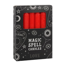 Load image into Gallery viewer, A pack of 12 black Magic Spell Candles in a black cardboard box with a witch themed pattern and the word "Love" at the bottom. The red candles can be seen in a cut out window in the packaging. Item on a white background.
